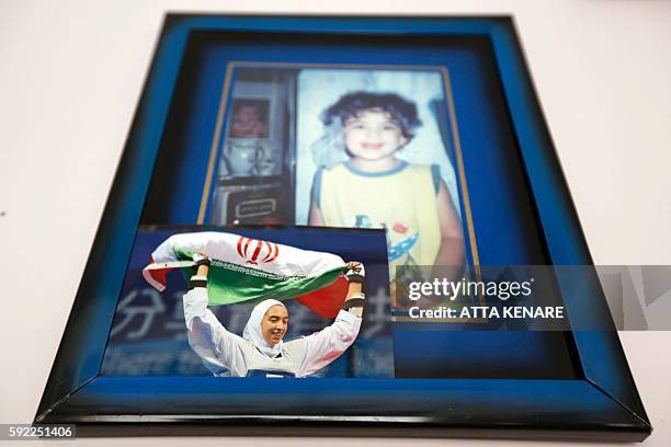 An image taken on August 20, 2016 shows a picture of Kimia Alizadeh, who became the first Iranian woman ever to win an Olympic medal, hanging in her...
