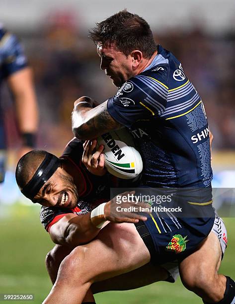 Kyle Feldt of the Cowboys is tackled by Thomas Leuluai of the Warriors during the round 24 NRL match between the North Queensland Cowboys and the New...