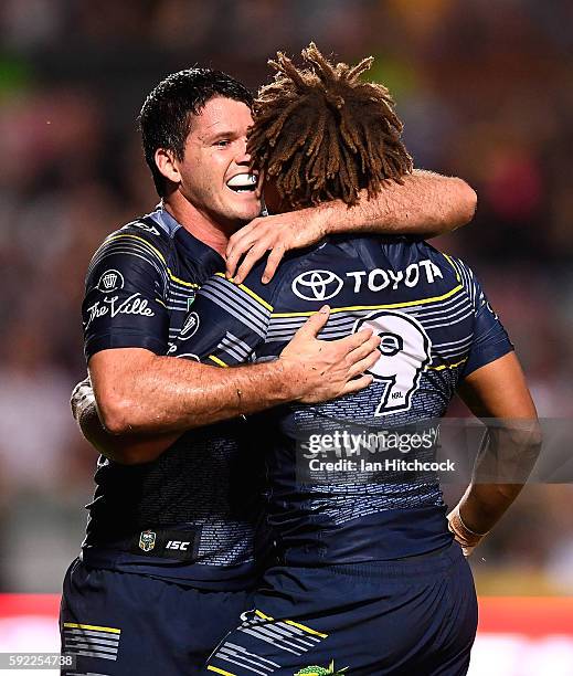 Ray Thompson of the Cowboys celebrates after scoring a try with Lachlan Coote during the round 24 NRL match between the North Queensland Cowboys and...