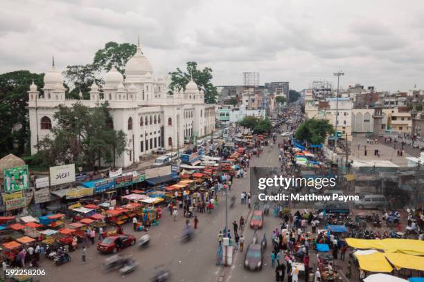 hyderabad, india: traffic moves down a highway in the old city near charminar - old city hyderabad india stock pictures, royalty-free photos & images