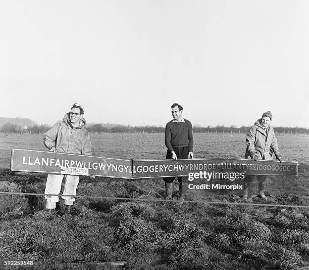 Pictured are TV engineers removing the sign from the mast. 4th February 1964.