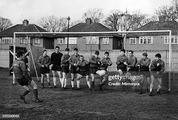 Liverpool Goalkeeper Tommy Lawrence takes a pot shot at the rest of the team, whicjh is lined up in the goal mouth at Melwood training ground January...