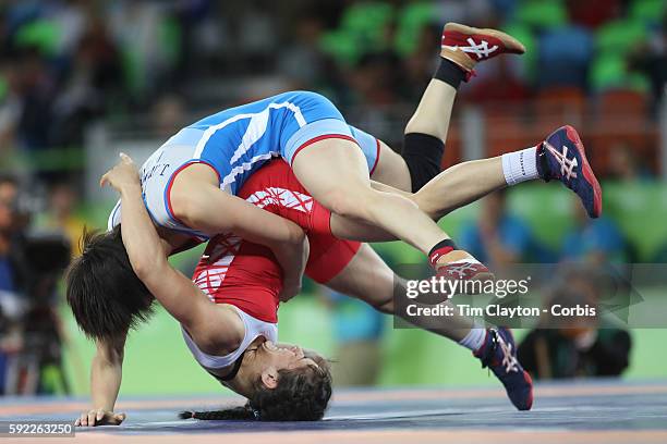 Day 13 Myong Suk Jong of Democratic People's Republic of Korea throws Bediha Gun of Turkey during her win in the Women's Freestyle 53 kg 1/8 Finals...