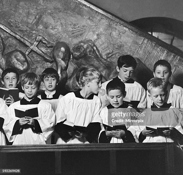Ten year old choirboy Ian Stacey of Bethnal Green tries to break the concentration of his friend by blowing bubbles with his bubble gum during choir...
