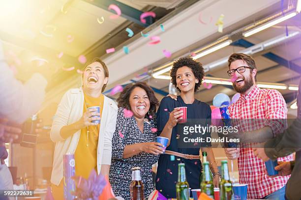 smiling business people at office party - festeggiamento foto e immagini stock