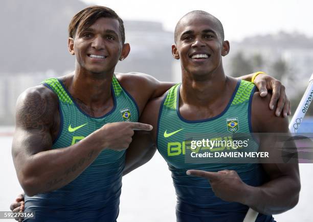 Brazil's Isaquias Queiroz Dos Santos and Brazil's Erlon De Souza Silva celebrate after the Men's Canoe Double 1000m final at the Lagoa Stadium during...