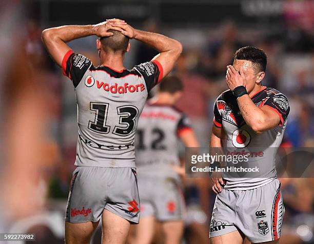 Nathaniel Roache and Simon Mannering of the Warriors react after conceding a drop out during the round 24 NRL match between the North Queensland...