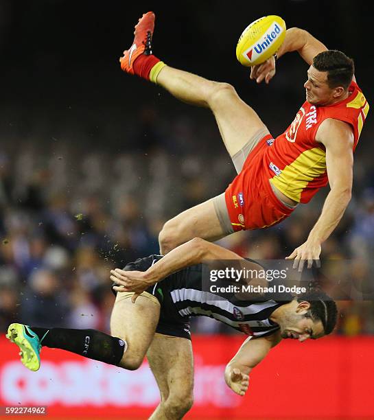 Steven May of the Suns collides with Brodie Grundy of the Magpies in a contest for the ball during the round 22 AFL match between the Collingwood...