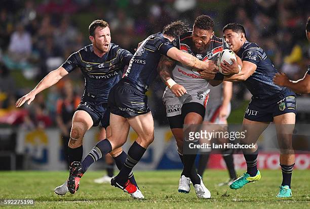 Manu Vatuvei of the Warriors is tackled by Jason Taumalolo and Rory Kostjasyn of the Cowboys during the round 24 NRL match between the North...