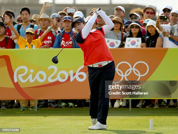 Shanshan Feng of China tees off on the first hole at the Women's Golf Final on Day 15 of the Rio 2016 Olympic Games at the Olympic Golf Course on...