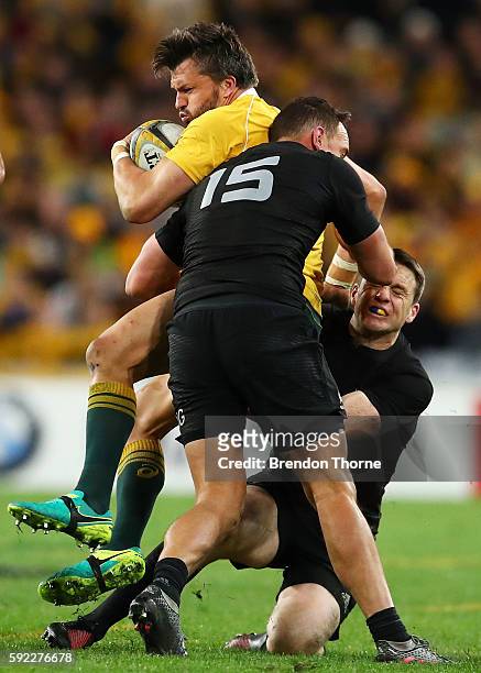 Adam Ashley-Cooper of the Wallabies is tackled by the All Blacks defence during the Bledisloe Cup Rugby Championship match between the Australian...