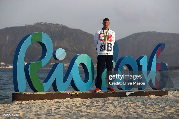 Giles Scott of Great Britain poses with his gold medal after winning the Finn class medal race at the Marina da Gloria on Day 14 of the 2016 Rio...