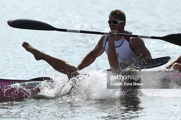 Max Rendschmidt of Germany jumps into the water after winning the gold medal in the Men's Kayak Four 1000m Finals on Day 15 of the Rio 2016 Olympic...