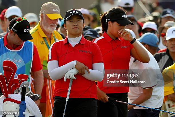 In Gee Chun and Amy Yang of Korea stand on the first tee during the Women's Golf Final on Day 15 of the Rio 2016 Olympic Games at the Olympic Golf...