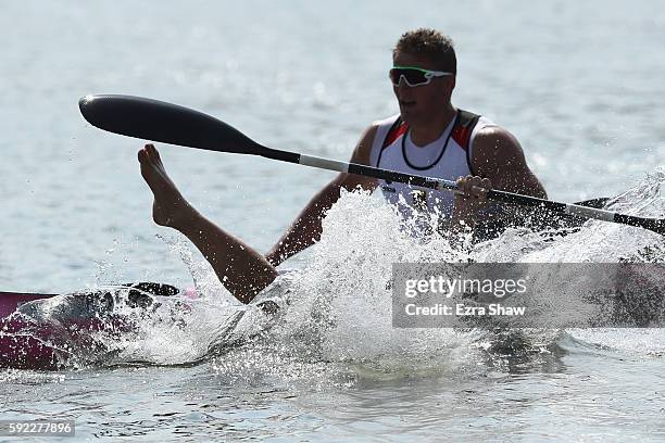 Max Rendschmidt of Germany jumps into the water after winning the gold medal in the Men's Kayak Four 1000m Finals on Day 15 of the Rio 2016 Olympic...