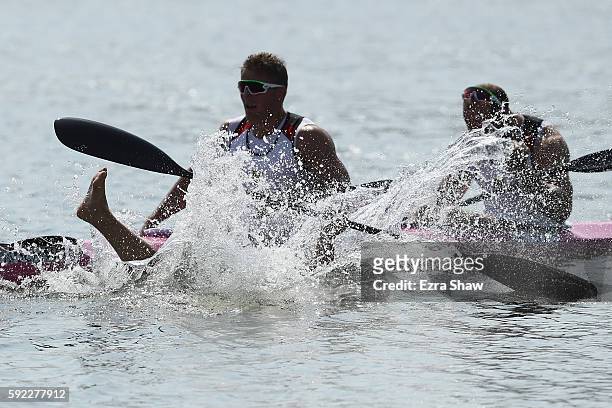 Max Rendschmidt of Germany jumps into the water after winning the gold medal in the Men's Kayak Four 1000m Finals on Day 15 of the Rio 2016 Olympic...