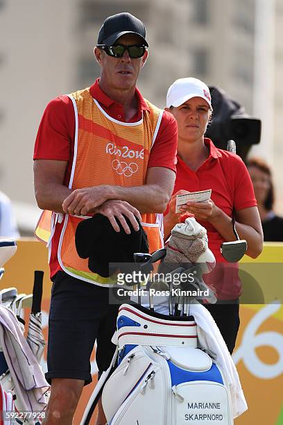 Caddie for Marianne Skarpnord of Norway, European Tour player Richard Green looks on from the eighth tee during the Women's Golf Final on Day 15 of...