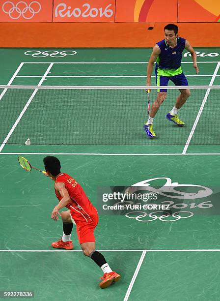 Malaysia's Lee Chong Wei returns to China's Chen Long during their men's singles Gold Medal badminton match at the Riocentro stadium in Rio de...