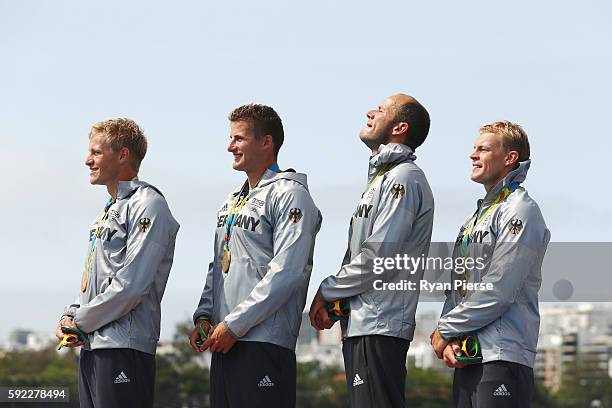 Max Rendschmidt, Tom Liebscher, Max Hoff and Marcus Gross of Germany celebrate winning the gold medal in the Men's Kayak Four 1000m Finals on Day 15...