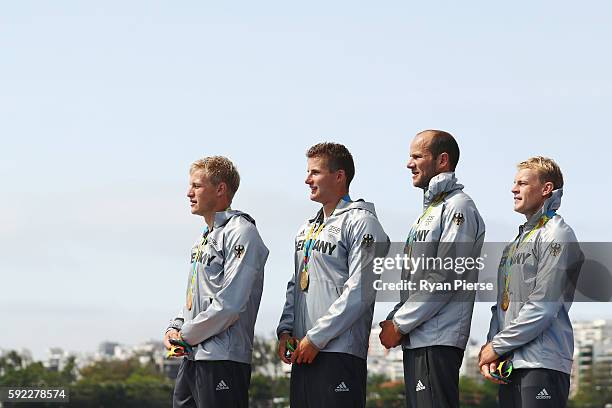 Max Rendschmidt, Tom Liebscher, Max Hoff and Marcus Gross of Germany celebrate winning the gold medal in the Men's Kayak Four 1000m Finals on Day 15...