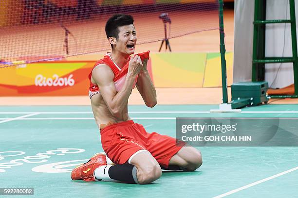 China's Chen Long reacts as he celebrates after winning against Malaysia's Lee Chong Wei during their men's singles Gold Medal badminton match at the...