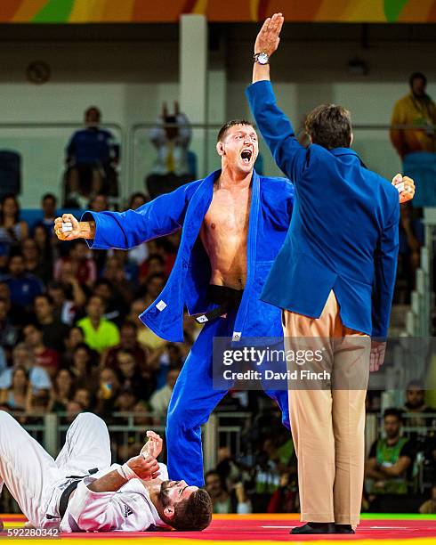 Lukas Krpalek of the Czech Republic leaps up after holding Cyrille Maret of France for an ippon to reach the u100kg final where he won the gold medal...