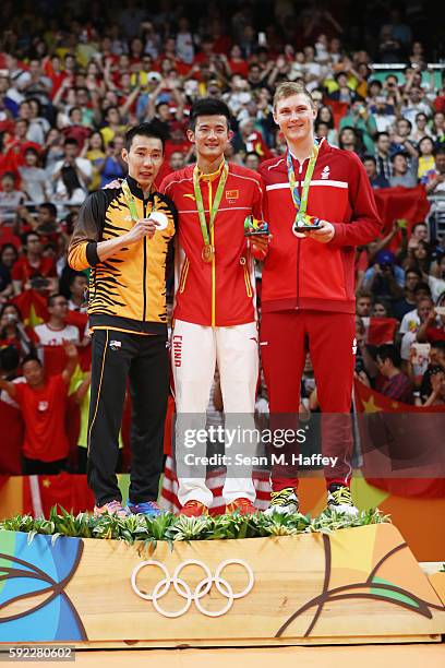 Silver medalist Chong Wei Lee of Malaysia, gold medalist Long Chen of China and bronze medalist Viktor Axelson of Denmark pose on the podium during...