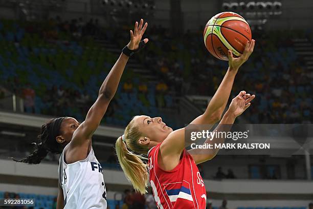 Serbia's point guard Milica Dabovic tries to score by France's point guard Olivia Epoupa during a Women's Bronze medal basketball match between...