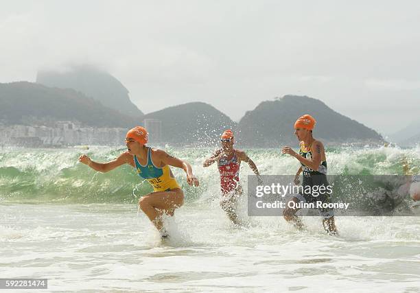 Ashleigh Gentle of Australia, Agnieszka Jerzyk of PolTrinidad and Tobago and Gillian Sanders of South Africa race from the water during the Women's...