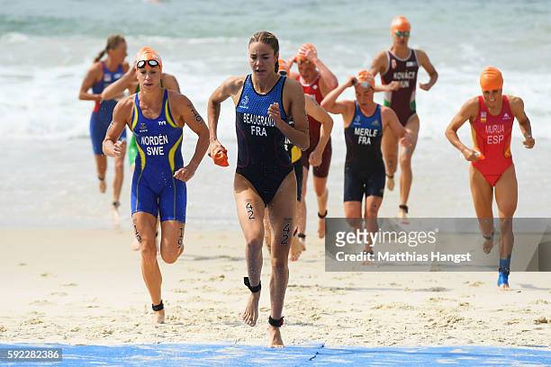 Cassandre Beaugrand of France and Lisa Norden of Sweden lead a group out of the water during the Women's Triathlon on Day 15 of the Rio 2016 Olympic...