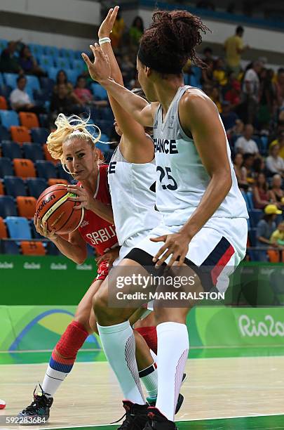 Serbia's point guard Milica Dabovic is blocked during a Women's Bronze medal basketball match between France and Serbia at the Carioca Arena 1 in Rio...