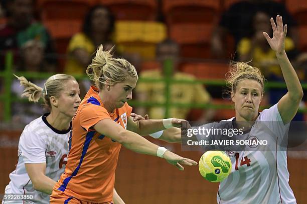 Netherlands' left back Estavana Polman vies with Norway's pivot Marit Malm Frajford during the women's Bronze Medal handball match Netherlands vs...