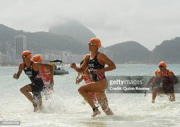 Sarah True of the United States, Helen Jenkins of Great Britain and Nicola Spirig Hug of Switzerland race from the water during the Women's Triathlon...
