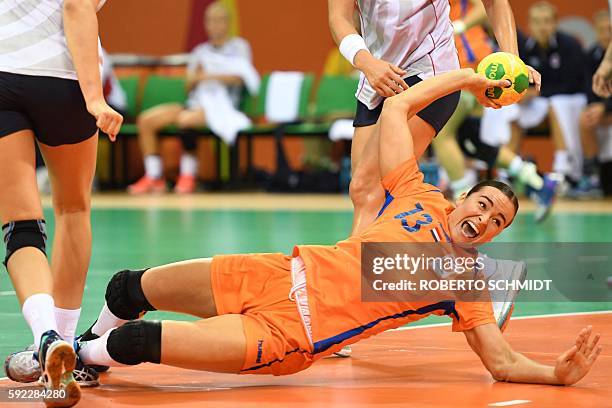 Netherlands' pivot Yvette Broch falls as she shoots during the women's Bronze Medal handball match Netherlands vs Norway for the Rio 2016 Olympics...