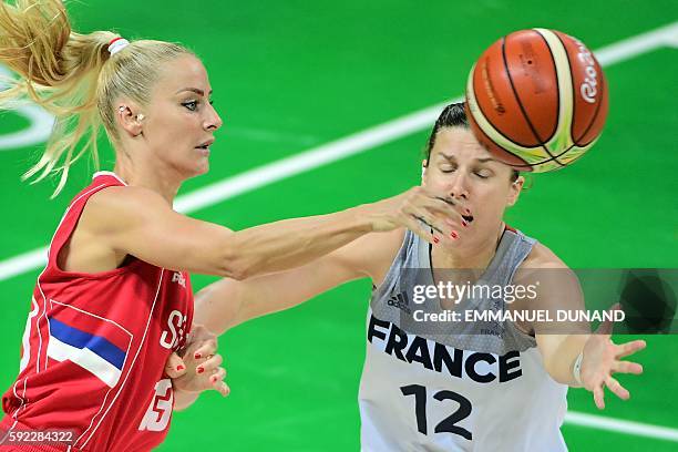 Serbia's point guard Milica Dabovic and France's guard Gaelle Skrela go for the ball during a Women's Bronze medal basketball match between France...