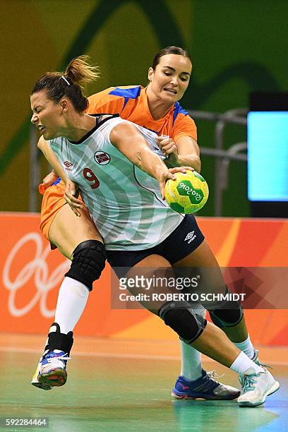 Norway's right back Nora Mork vies with Netherlands' pivot Yvette Broch during the women's Bronze Medal handball match Netherlands vs Norway for the...