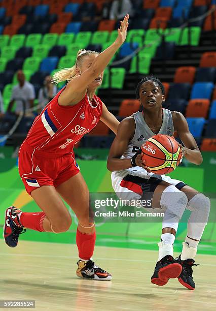 Olivia Epoupa of France handles the ball against Milica Dabovic of Serbia during the Women's Bronze Medal basketball game between France and Serbia...
