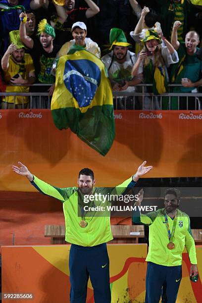 Brazil's gold medallists Alison Cerutti and Bruno Oscar Schmidt celebrate on the podium at the end of the men's beach volleyball event at the Beach...