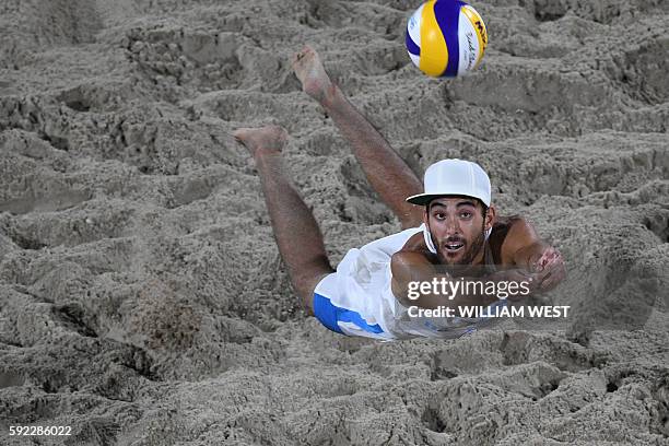 Italy's Paolo Nicolai returns the ball during the men's beach volleyball final match between Italy and Brazil at the Beach Volley Arena in Rio de...