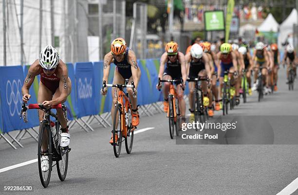 Switzerland's Nicola Spirig leads other athletes competing in the cycling portion of the women's triathlon at Fort Copacabana during the Rio 2016...