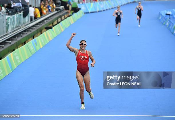 Switzerland's Nicola Spirig crosses the finish line to win the silver medal in the women's triathlon at Fort Copacabana during the Rio 2016 Olympic...