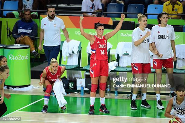Serbia's point guard Milica Dabovic and Serbia's shooting guard Ana Dabovic cheer on during a Women's Bronze medal basketball match between France...