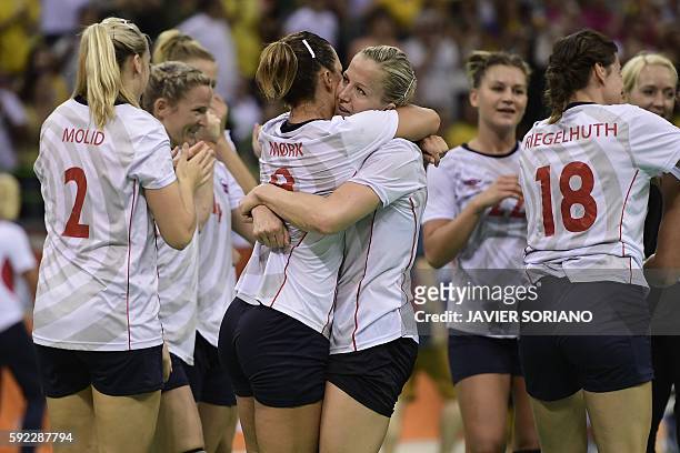 Norway's right back Nora Mork and Norway's pivot Heidi Loke celebrate their victory at the end of the women's Bronze Medal handball match Netherlands...