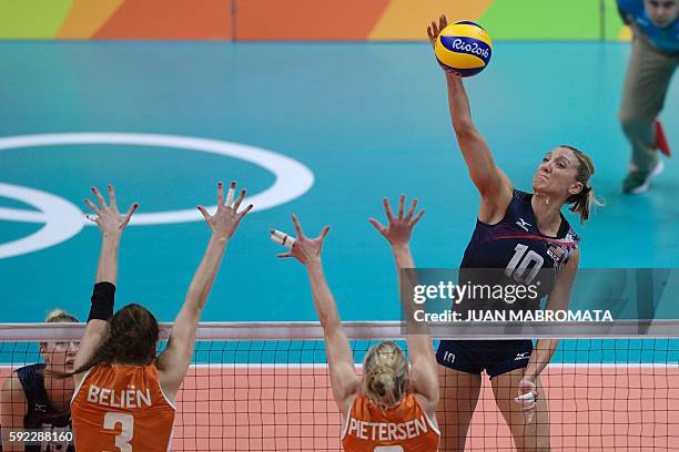 S Jordan Larson-Burbach spikes the ball during the women's bronze medal volleyball match between the Netherlands and USA at Maracanazinho Stadium in...