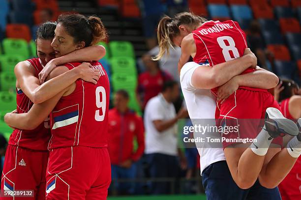 Sonja Petrovic, Jelena Milovanovic and Nevena Jovanovic of Serbia react after defeating France 70-63 in the Women's Bronze Medal basketball game on...