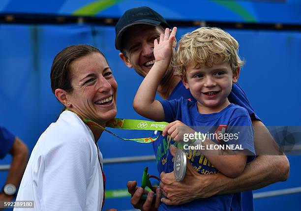 Switzerland's Nicola Spirig celebrates with her family after receiving the silver medal in the women's triathlon at Fort Copacabana during the Rio...