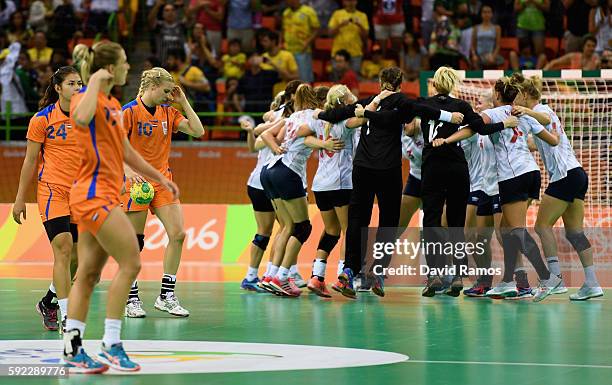 Norway players celebrate their victory while Estavana Polman of Netherlands looks dejected following the Women's Handball Bronze medal match between...
