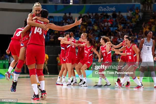 Milica Dabovic of Serbia celebrates with teammate Ana Dabovic after defeating France 70-63 in the Women's Bronze Medal basketball game on Day 15 of...