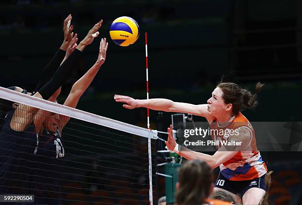 Lonneke Sloetjes of Netherlands spikes the ball against Jordan Larson-Burbach and Rachael Adams of United States during the Women's Bronze Medal...