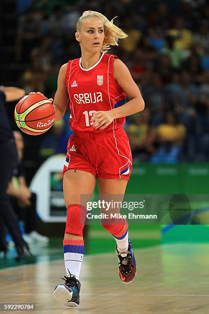 Milica Dabovic of Serbia moves the ball during the Women's Bronze Medal basketball game between France and Serbia on Day 15 of the Rio 2016 Olympic...